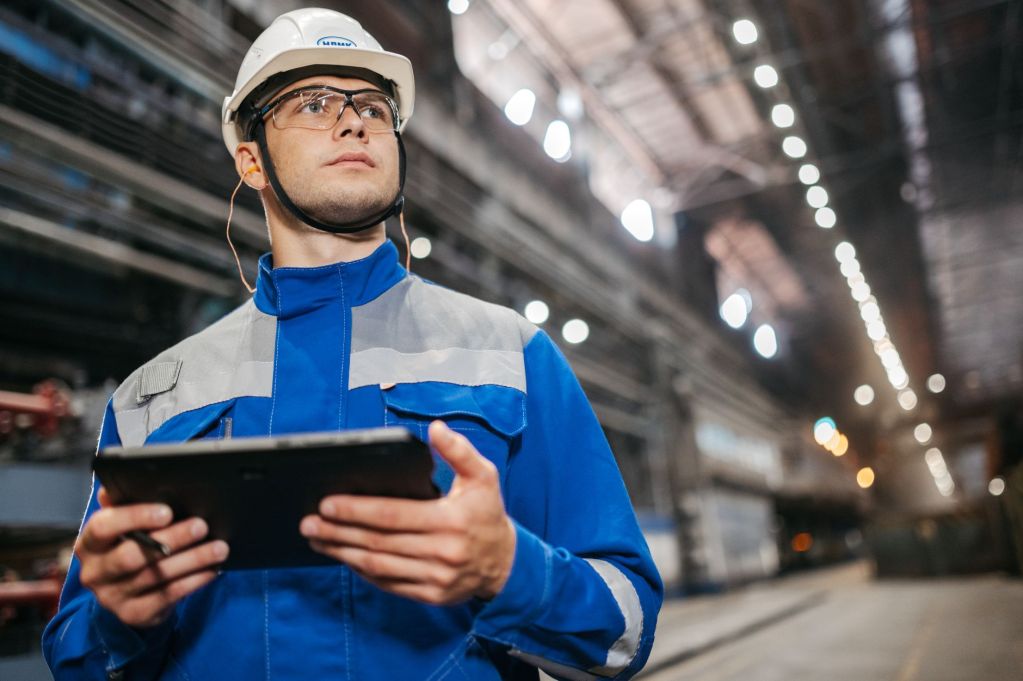 industrial worker using tablet in factory