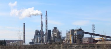 industrial factory with emissions under blue sky